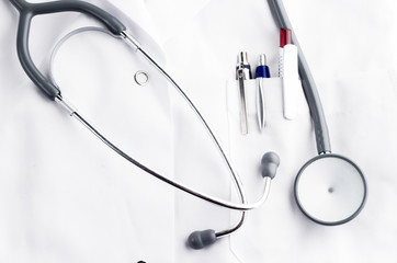 stethoscope and ballpoins on doctor's lab coat