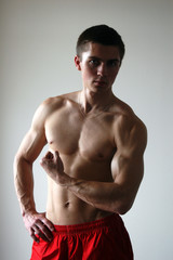 Young Muscular Man Flexing His Biceps