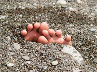 toes and pebble