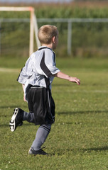 boy playing soccer