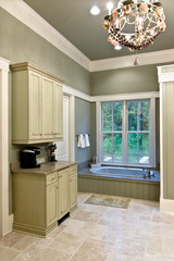 expensive bathroom with custom cabinets and whirlpool