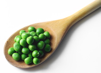 Green peas and wood spoon