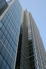 looking up a very tall steel office building