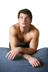 Obraz premium Sexy Muscular Man Leaning on the Sofa