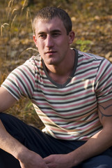 Fototapeta premium Young man sit in the forest