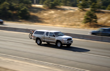 Panning of tan pickup truck with bikes