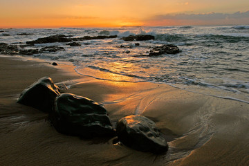 Seascape at sunrise with golden reflections 