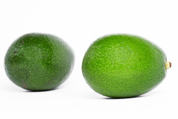 Avocado fruits on white