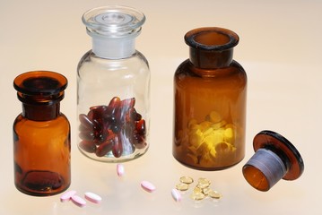 Glass full of  pharmaceuticals on color background