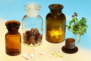 Glass full of  pharmaceuticals on color background
