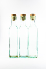 Three empty glass bottles isolated on white