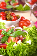 Fresh salad with onion tomato and basil