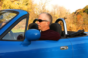 Middle-aged Man in a Blue Convertible