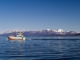 Old fishing boat on the sea in Northern Norway