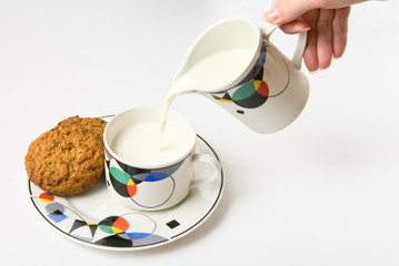 Woman, pouring milk to cup