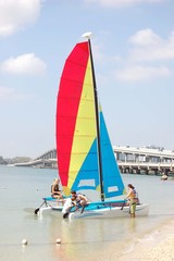 Vacationers Launching a Catamaran