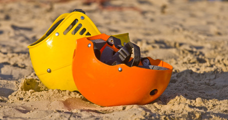 Obraz premium Two colourful helmets in the sand