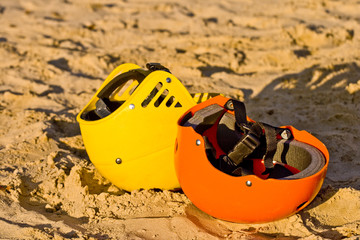 Two colourful helmets in the sand