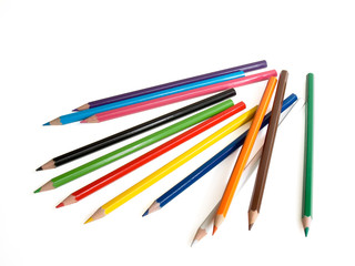 The multi-coloured pencils lay on a white background