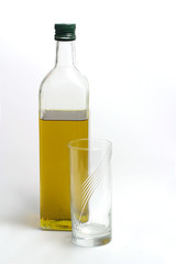 Bottle of olive oil with transparent mug