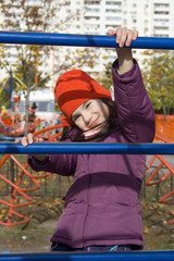 Fototapeta premium child girl hold on ladder