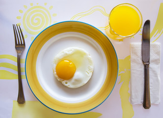 Breakfast with fried egg and orange juice  