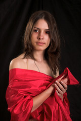 Fototapeta premium young beauty girl in the red isolated on black
