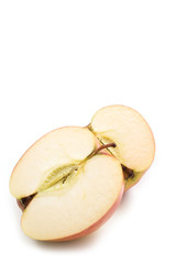 Still life of sliced red apples on white background