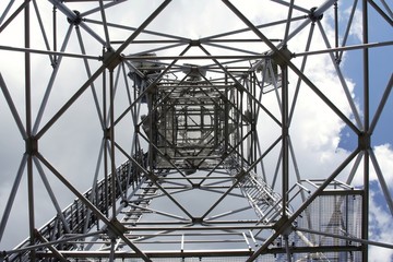  metal structure of antenna mast under sky with clouds