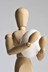 Mannequin holding an egg 