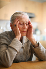 Senior woman relaxing to end headache. Shallow DOF.