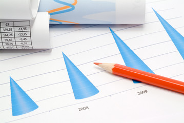 Business accessories on a background of diagrams.