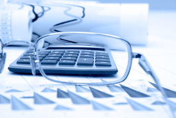 Business accessories on a background of diagrams.