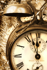 Vintage alarm-clock in sepia tone. New Year celebration
