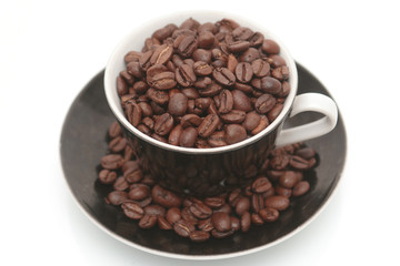 The black cup with fragrant coffee costs on a table