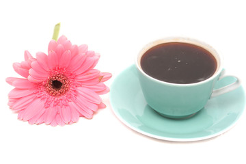 Fototapeta na wymiar The cup from coffee and a pink flower is on a white background 