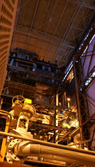 Equipment, cables and piping as found inside of a modern industr