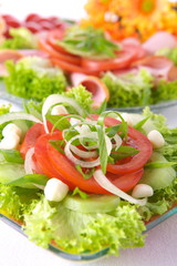 Fresh salad with onion, tomato and basil