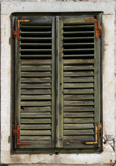 Faded old window shutters with rusty hinges