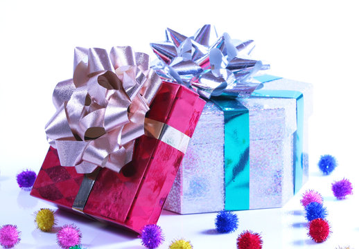 Shiny presents with ribbons and bows on white background.