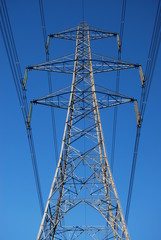 Power lines against blue sky