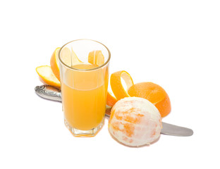 glass with orange juice and knife and orange and orange skin
