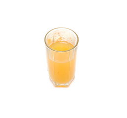 glass with orange juice and orange behind him