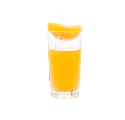 glass with orange juice and orange segment on it