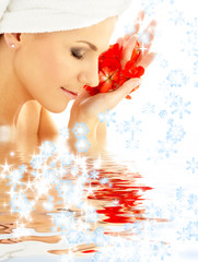 lady with red petals and snowflakes in water