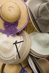 A rack of ladies straw hats on display.