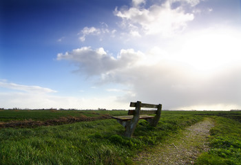 empty wooden bench in rural landscape - 5128907