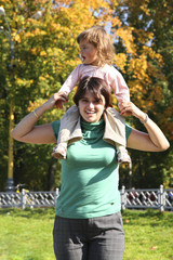 mother with daughter in autumn park