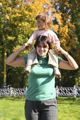 Obraz premium mother with daughter in autumn park