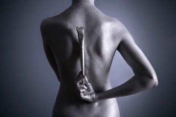 Nude woman with silver make-up